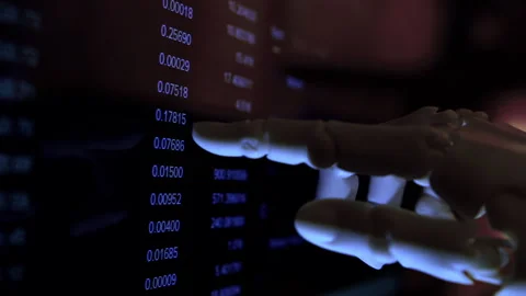 AI humanoid robot arm reading financial charts on a monitor. Stock Footage 337910481