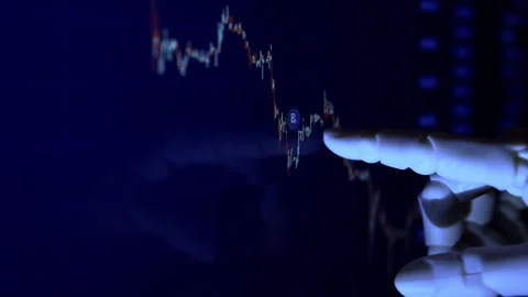 AI humanoid robot arm reading financial data on a monitor Stock Footage 337963797