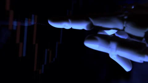 AI humanoid robot arm tracking stock charts on a computer screen. Stock Footage 337962219