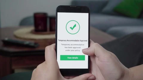 AI Insurance App Approves Temporary Accommodation Claim on Phone Stock Footage 341932360