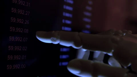 AI robotic arm analyzing high-frequency financial data on a monitor. Stock Footage 337911137