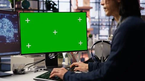 AI startup office senior developer building application on green screen computer Stock Photos