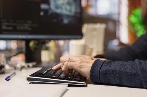 AI startup office software developer typing on computer keyboard, close up Foto stock