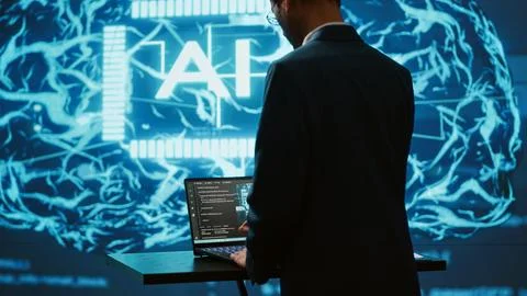 AI system administrator using laptop device in high tech futuristic workspace Foto stock