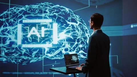 AI system administrator using laptop device in high tech futuristic workspace Stock Photos