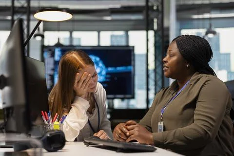 AI tech startup engineer confiding personal struggles to her friend at work Stock Photos