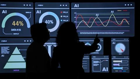 AI Using. Silhouetted analysts interact with a large AI data display. Foto stock