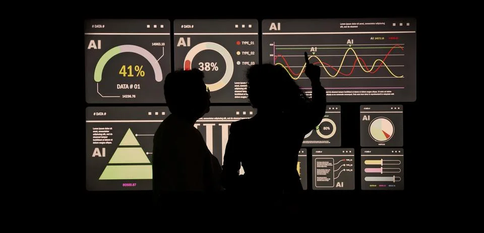 AI Using. Silhouetted analysts interact with a large AI data display. Stock Photos