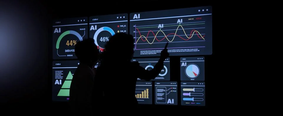 AI Using. Silhouetted analysts interact with a large AI data display. Stock Photos