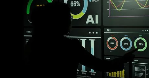 AI Using. Silhouetted analysts interact with a large AI data display. Foto stock
