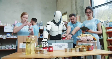 Aid workers with android robot putting food and drinks into boxes for delivery Stock Footage 193989727