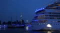 AIDA Stella blue illuminated stern leaving Hamburg harbor sailboats HD Footage