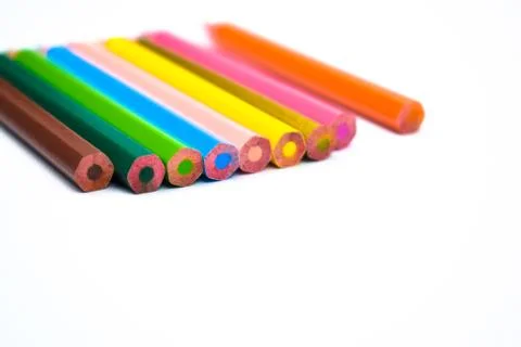 Aide view of a line of different colored wood pencil placed on a white backgr Stock Photos