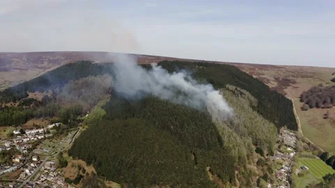 Aieral view of fire spreading on a mountain forest from kids starting fires in 스톡 동영상 153054437