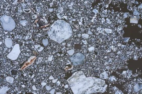 Aierial view from the top down on ice floes floating on the river. Stock Photos