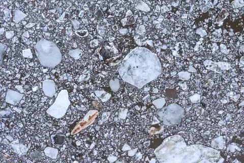 Aierial view from the top down on ice floes floating on the river. Stock Photos