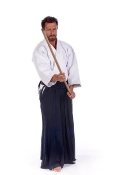 Aikido master with sword in attack position Stock Photos