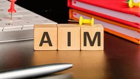The AIM concept word is assembled from cubes. Business concept Stock Photos