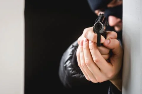 Aiming murderer with a gun Stock Photos