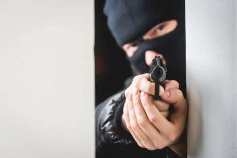 Aiming murderer with a gun Stock Photos