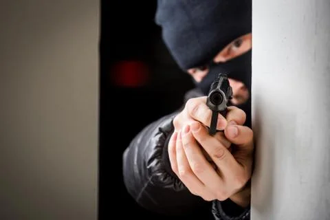 Aiming murderer with a gun Stock Photos