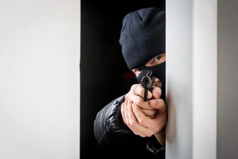Aiming murderer with a gun Stock Photos