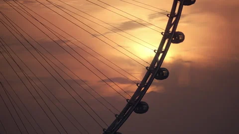 Ain Dubai ferris wheel sunset golden sky dramatic clouds Stock Footage 257777970