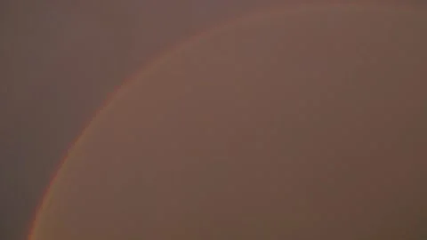 Ainbow arching across a cloudy sky. Beautiful meteorological phenomenon Stock Footage 336493726