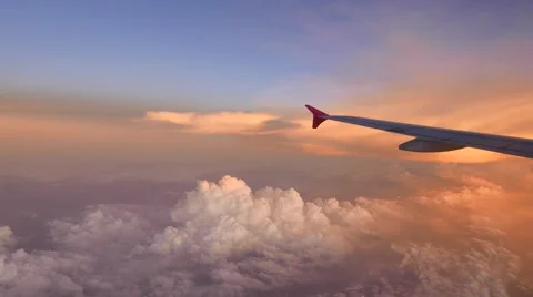 Aiprlane fly to bright reddish clouds, sunset lighting, beautiful afterglow Stock Footage 50541824