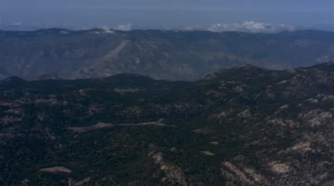 Air-to-air orbiting view of business jet over rugged terrain Stock Footage 59476509