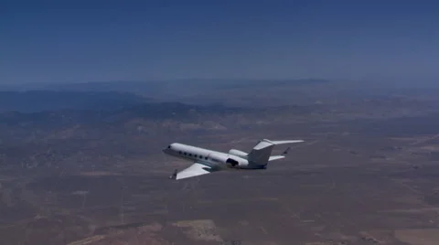 Air-to-air side and overhead views of small jet in flight Stock Footage 59475997