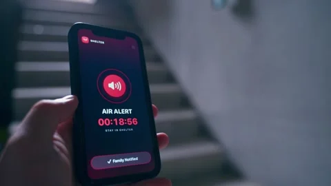 Air alert app on smartphone screen with timer and shelter warning in stairwell Video stock 342603589