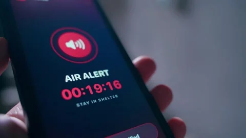 Air alert warning on smartphone screen with countdown timer and stay in shelter Видео 342940735