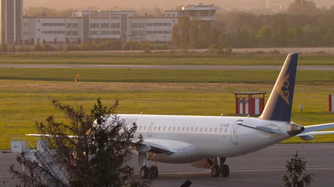 Air Astana Embraer E190-E2 aircraft parked at Almaty Airport at sunset Stock Footage 335942857