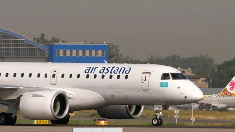 Air Astana Embraer E190-E2 starts takeoff roll at Almaty Airport Stock Footage 339106058