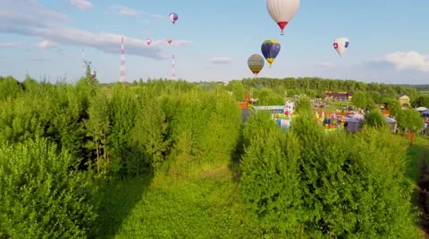 Air Balloons fly above fields at summer day in Pereslavl Zalessky Stock Footage 58497683