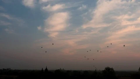 Air balloons  hyper lapse and zoom at sunrise under Bagan of Myanmar Stock Footage 76456343