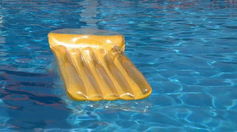 Air bed floating on swimming pool Stock Footage 360294
