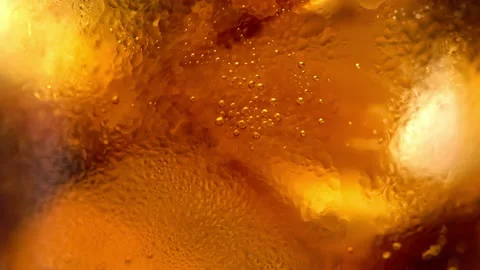 Air bubble floating up after pouring cola in a glass filled with ice cubes. Stock Footage 147197665