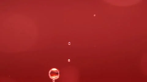 An air bubble forms in the red liquid Stock Footage 133250355