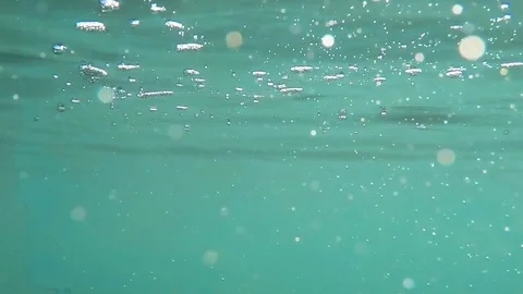 Air bubbles and shining glare in the water Stock Footage 84549393