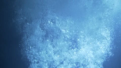 Air bubbles in blue water when illuminated by light rays. Video stock 247470823