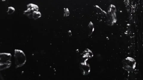 Air bubbles in boiling water on a black background. Vertical video Stock Footage 273079822