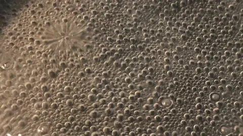 Air bubbles in boiling water Stock Footage 146711139