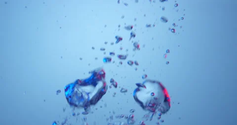 Air bubbles colored in blue and red rising up on blue background. Stock Footage 151643673