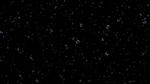 Air bubbles of different sizes tend upward ahead of each other on a black Stock Footage 153768212
