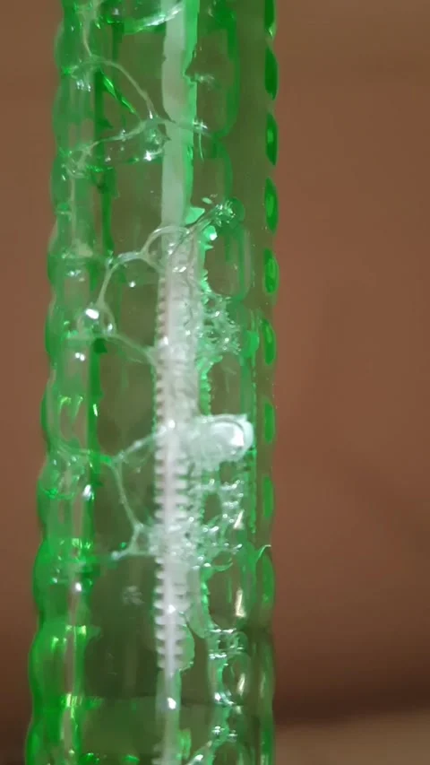 Air Bubbles Forming a Chain and Zigzag Pattern in Liquid Stock Footage 343864519
