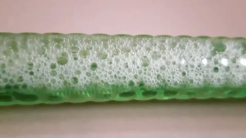 Air Bubbles Moving in a Continuous Flow Inside Green Liquid 库存影片 343368096