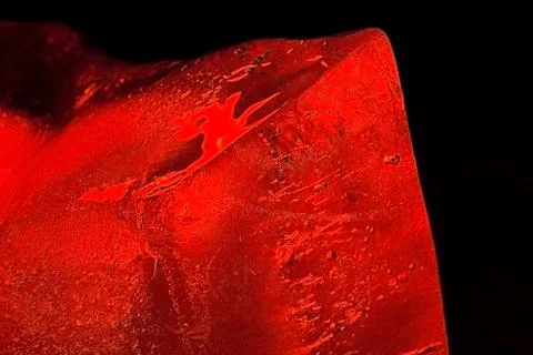 Air bubbles in red ice cube Stock Photos