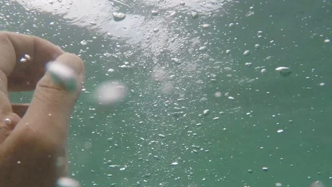 Air bubbles rise from depth to surface Stock Footage 93934236